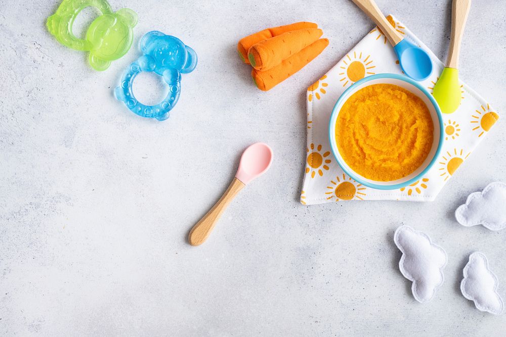 Healthy baby food background, organic carrot puree