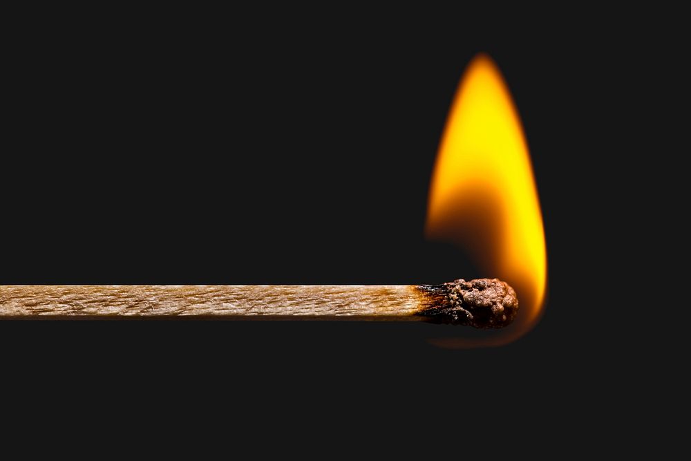 Burning matchstick stock image, black background psd with design space