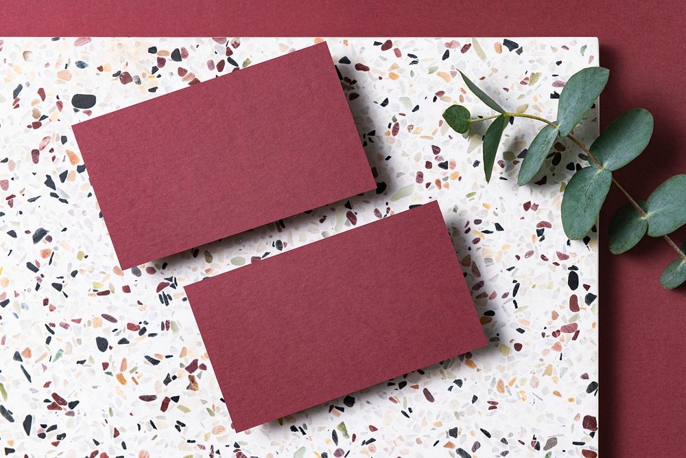 Red business cards, terrazzo background, flat lay design