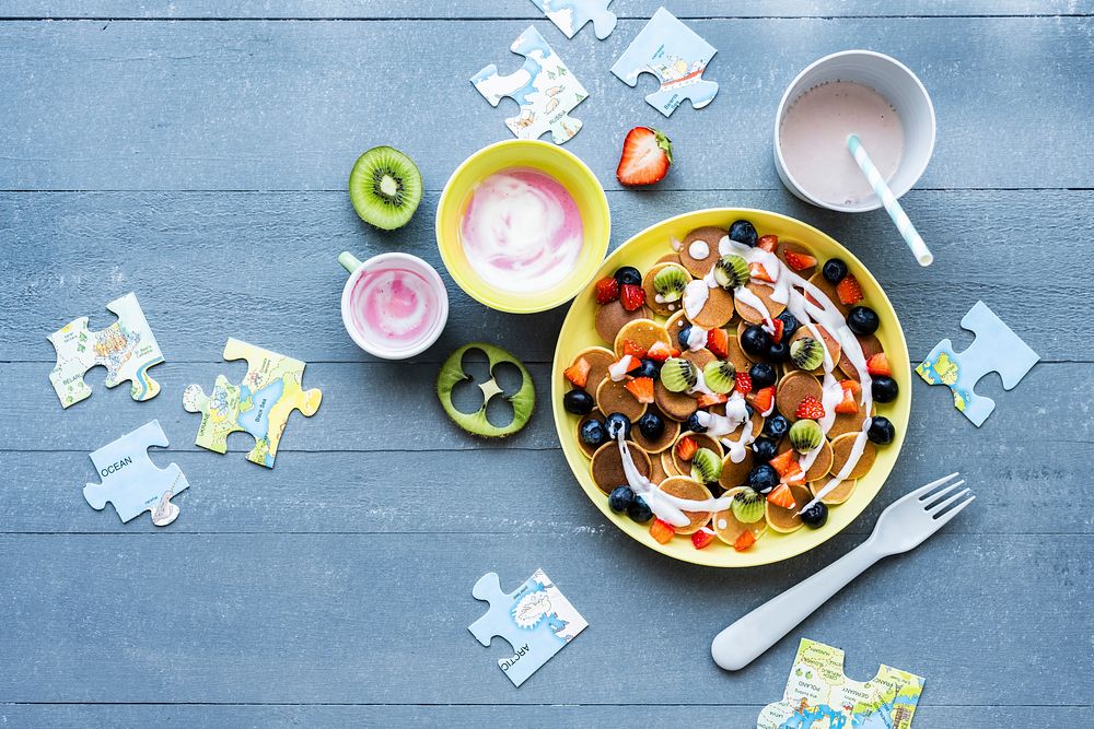 Kids mini pancakes treat background, wallpaper with kiwi and berries