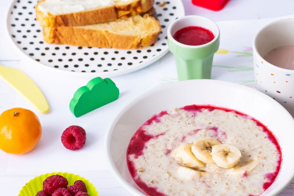Kids porridge, raspberry sauce, healthy breakfast