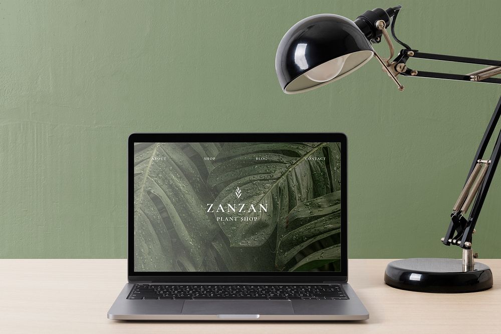 Minimal workspace, laptop screen showing online plant shop website
