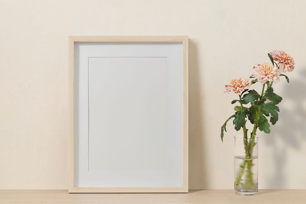 Blank picture frame, pink chrysanthemum in a vase