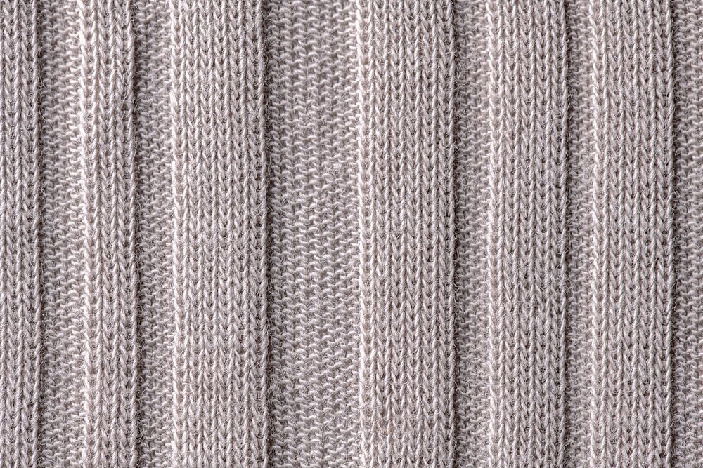 Knitted fabric texture, beige background, macro shot