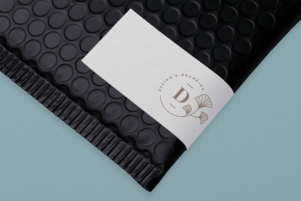 White shipping label mockup, black bubble mailer bag psd