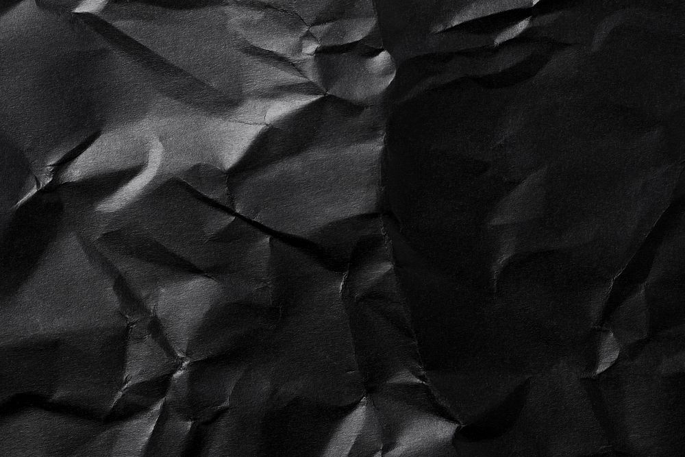 Black background, crumpled paper texture design