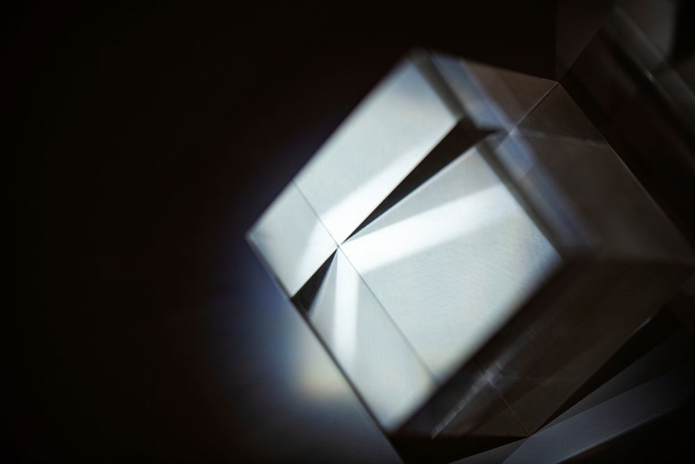 Gray metallic box in a dark room with light rays 