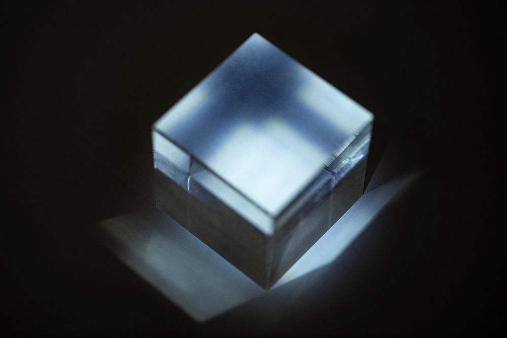 Gray metallic box in a dark room with light rays 