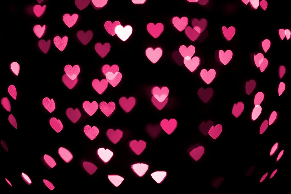Pink  glitter heart bokeh sequin confetti on black background