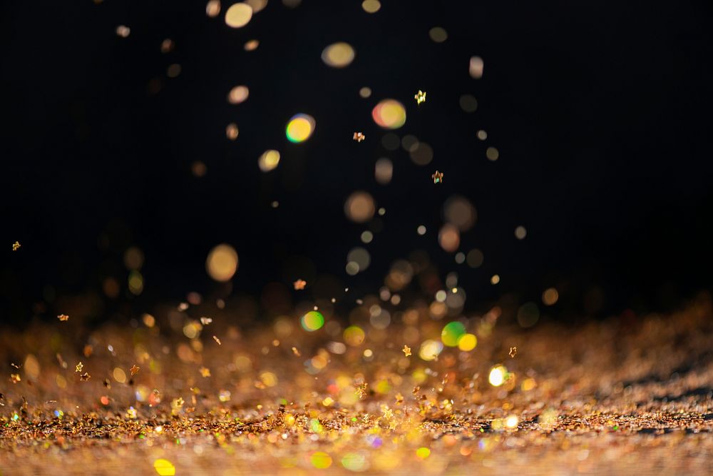 Gold falling glitter sequin confetti on black background
