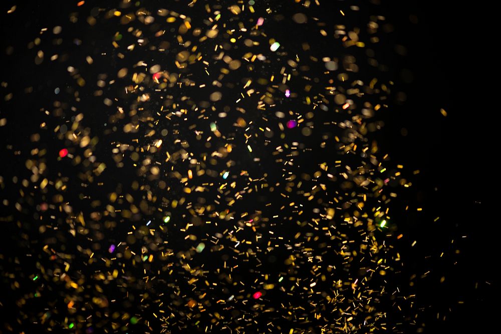 Gold falling glitter sequin jewel confetti on darl black background