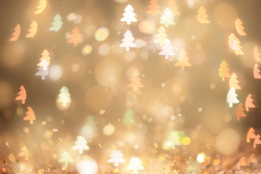 Gold glitter Christmas tree bokeh sequin confetti on black background in warm light 
