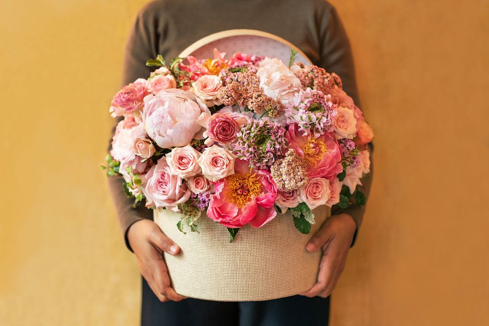 Woman holding pink flowers basket