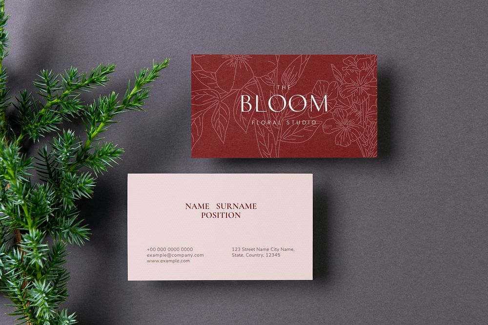 Business card mockup, pink and red design, flat lay with leaf design psd