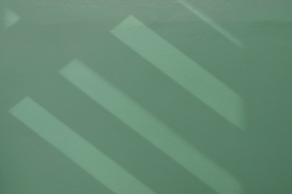 Stair shadow on clean green textured wall