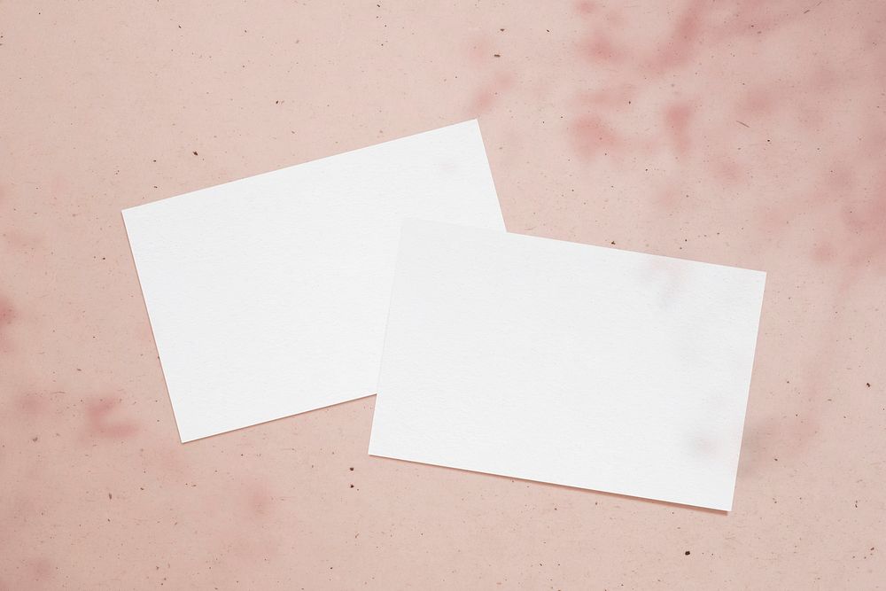 Blank white cards on a pink background