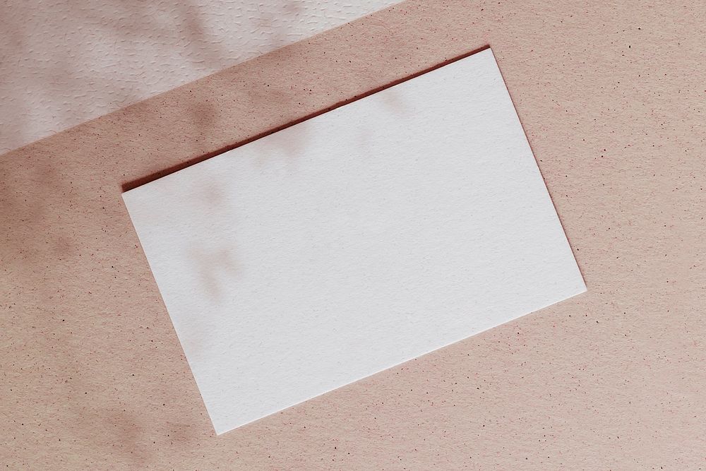 Blank white card on a pink background