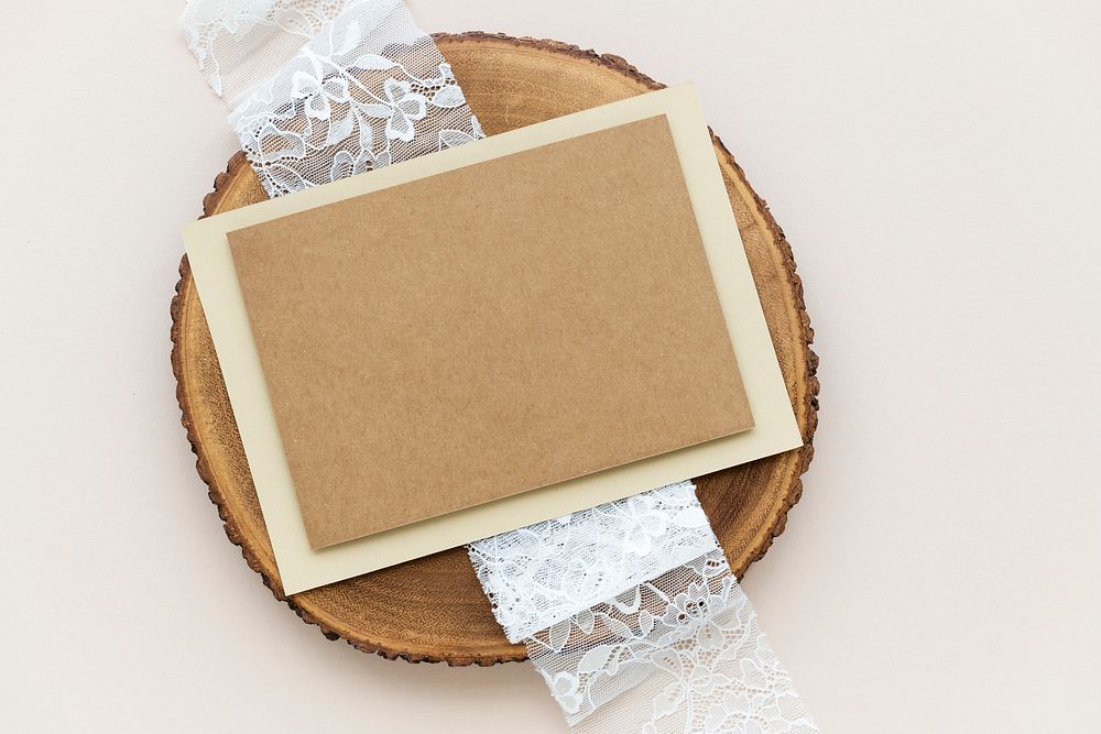 Blank brown card on a wooden plate