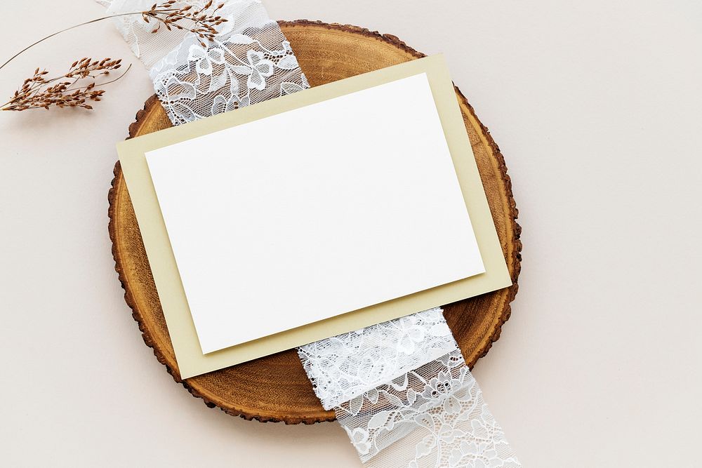 Blank white card on a wooden plate