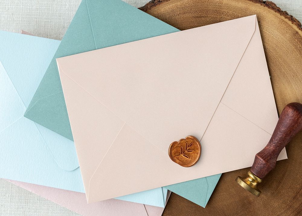 Blue and pink envelopes on a wooden plate
