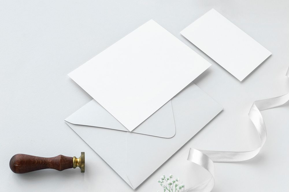 Blank white cards with a stamper and white ribbon