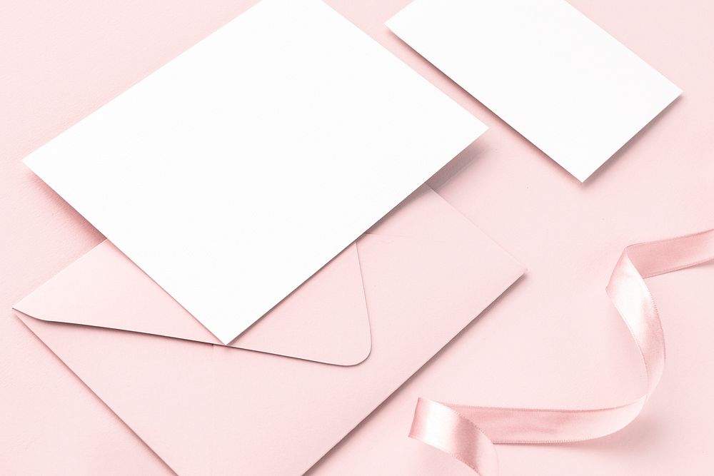 Blank card and envelope on a pink background