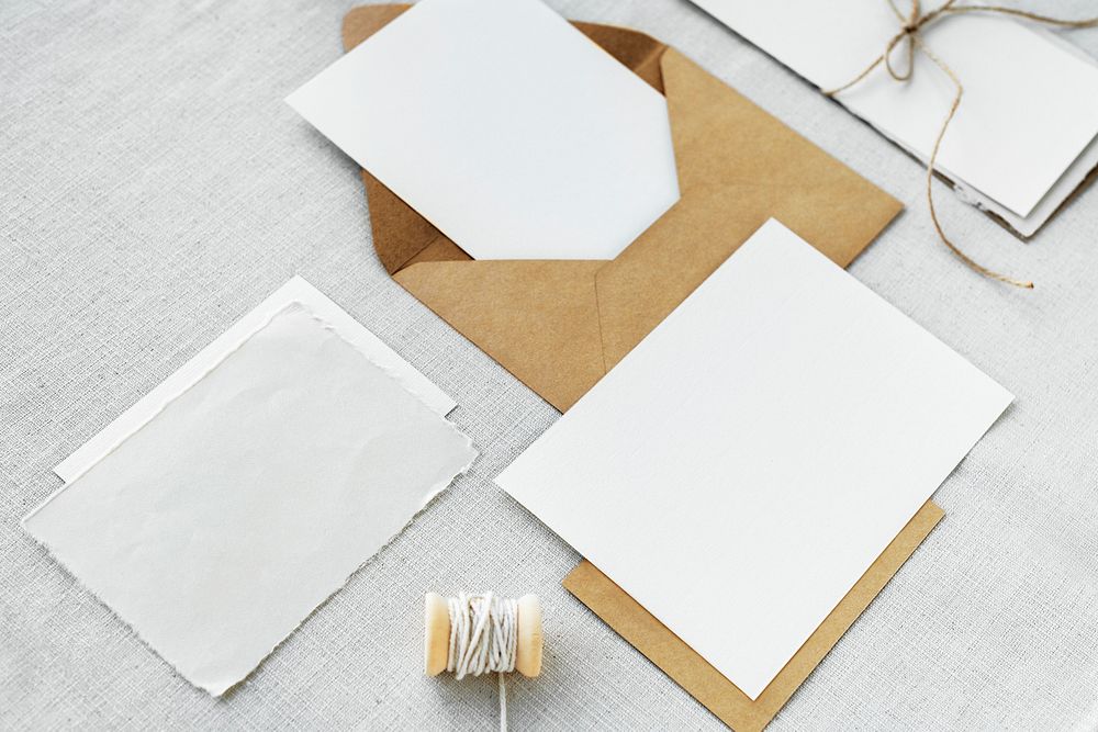 Blank white cards on fabric textured background
