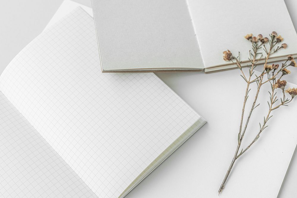 Blank white notebooks with dried plant