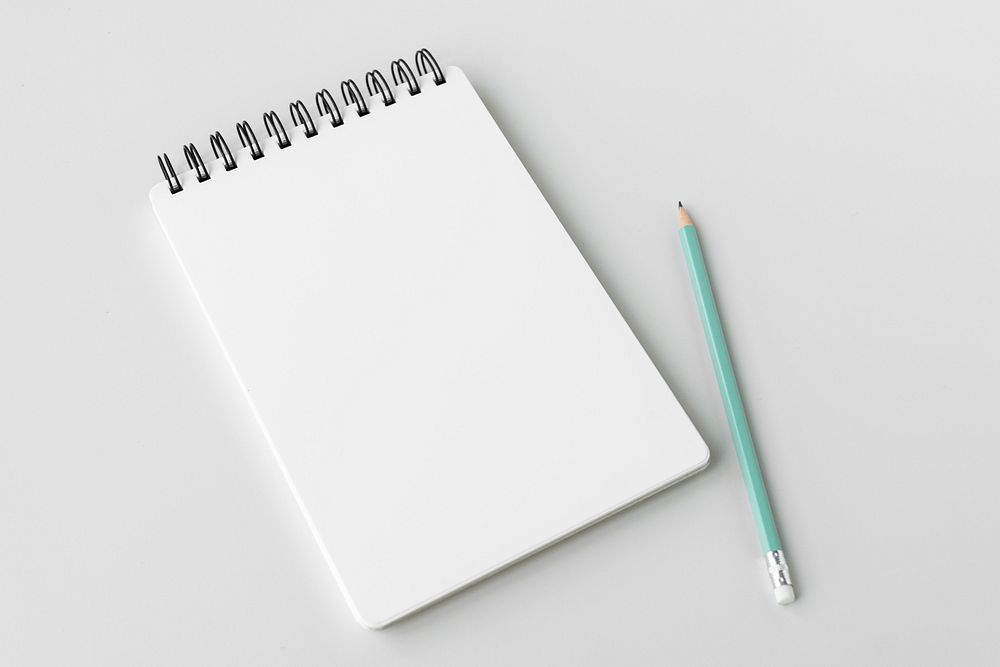 Blank plain white notebook with a pencil