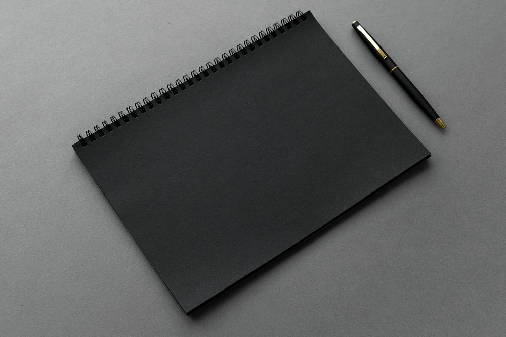 Black notebook with a pen mockup