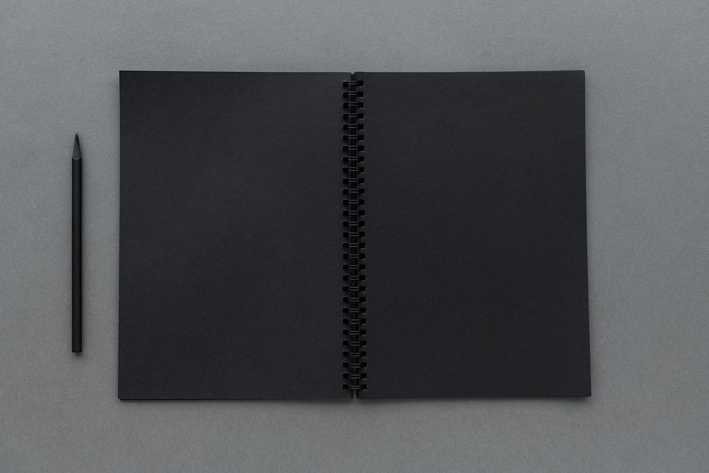 Black notebook with a pencil