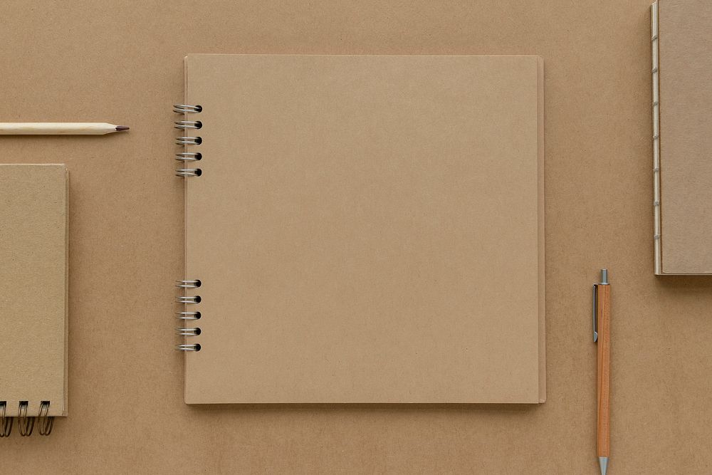 Natural brown paper notebook with pencils mockup
