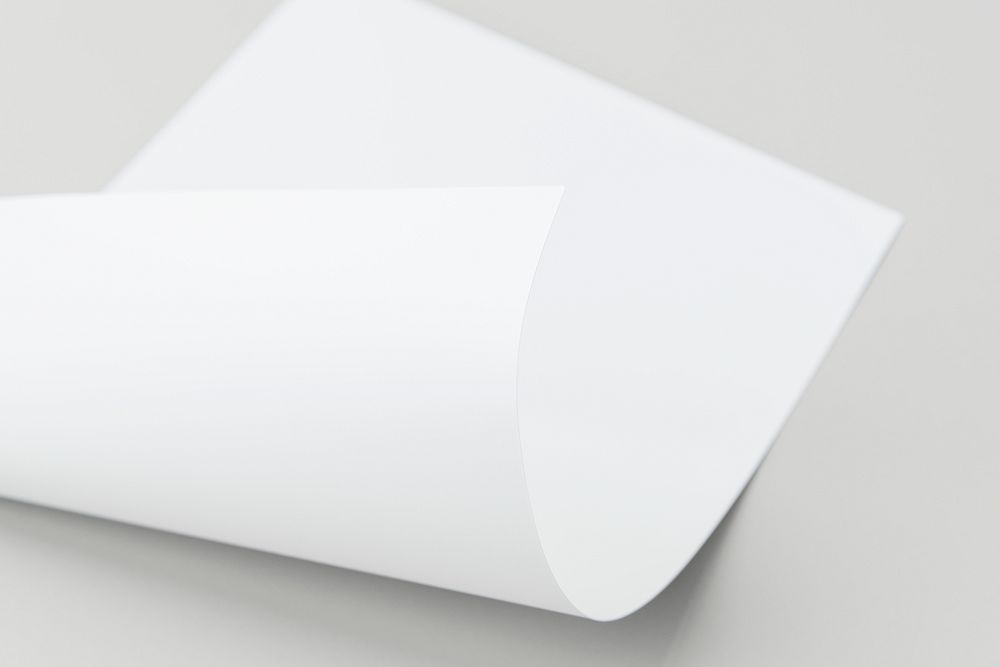 Blank white folded paper on a gray background