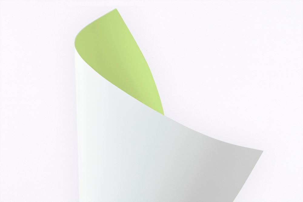 Blank green and white folded paper on a gray background