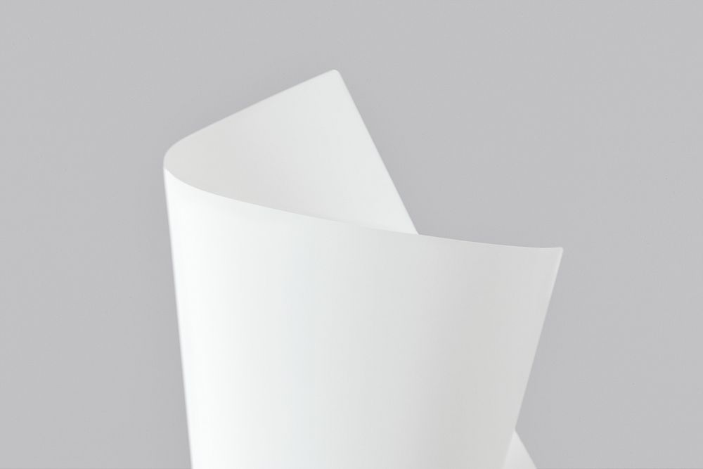 Blank white folded paper mockup on a gray background