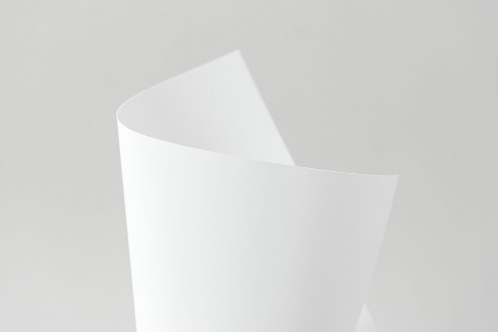 Blank white folded paper on a gray background
