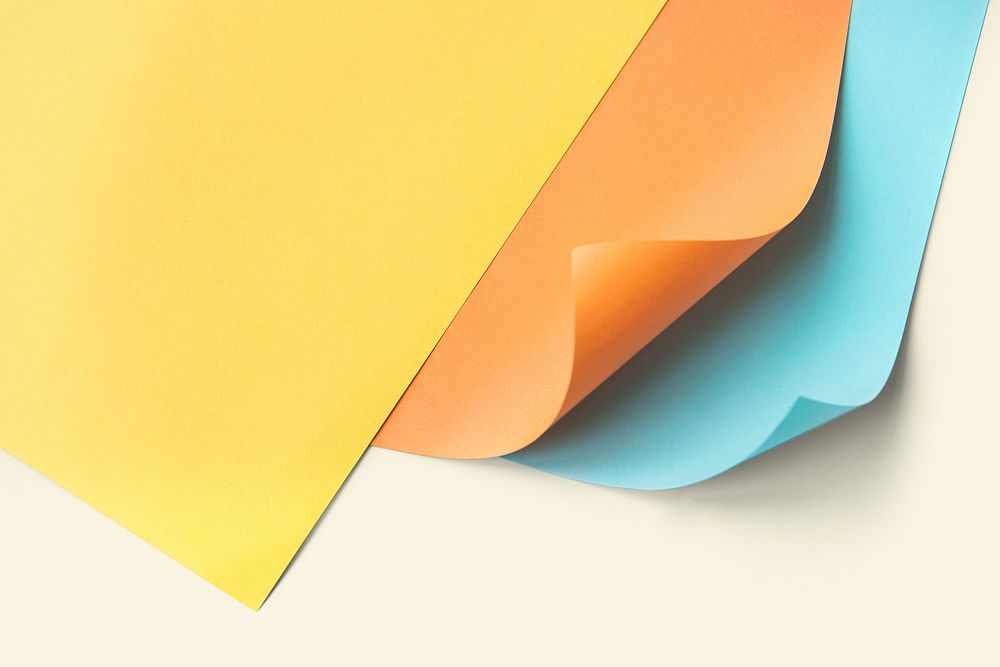 Colorful curled paper mockup on a pale yellow background