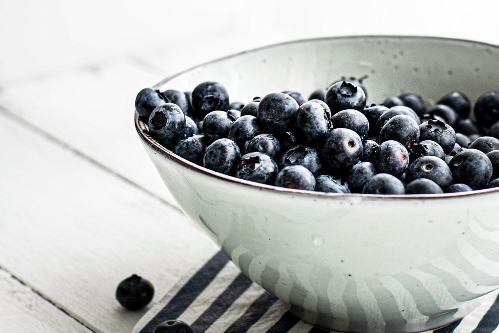 Blueberries in a white ceramic bowl. Visit Monika Grabkowska to see more of her food photography.
