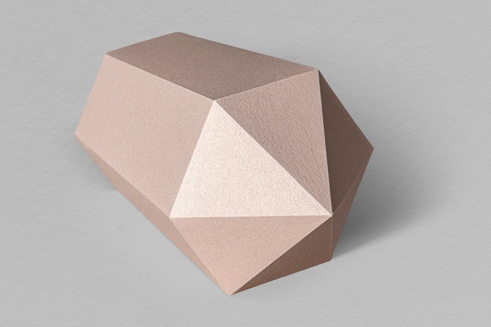 Pink hexagonal prism  paper craft on a gray background