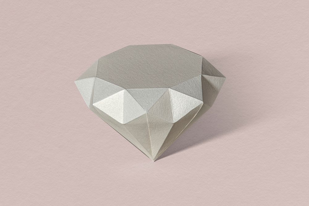 3D silver diamond shaped paper craft on a dull pink background