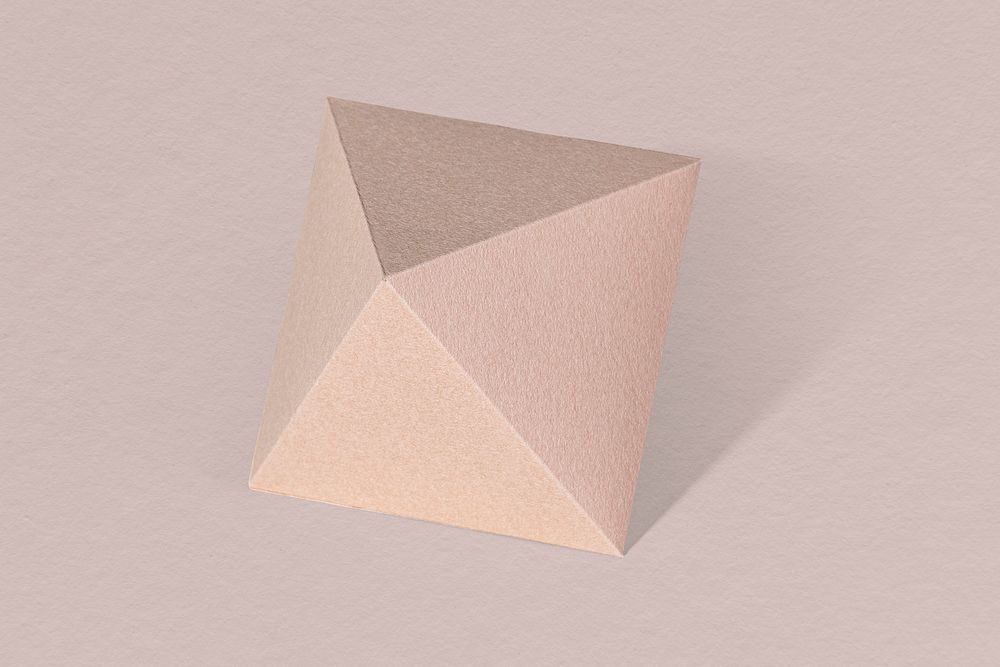 3D pink pyramid paper craft on a dull pink background
