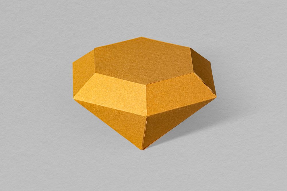 3D golden diamond shaped paper craft on a gray background