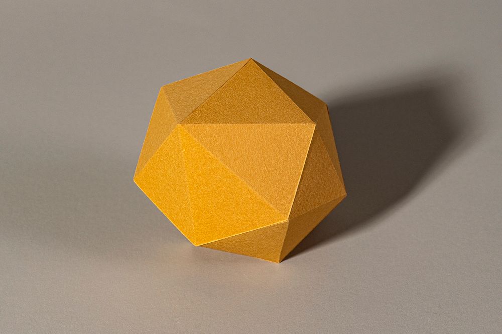 3D golden pentagon shaped paper craft on a gray background