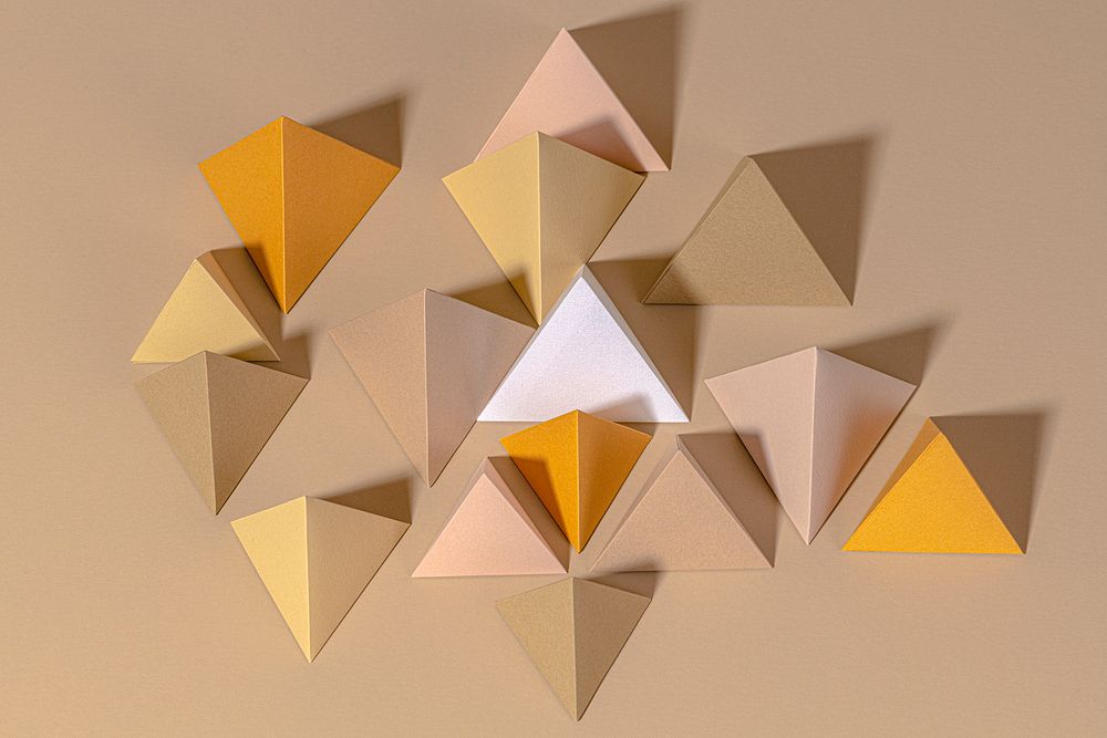 3D pyramid paper craft on a beige background