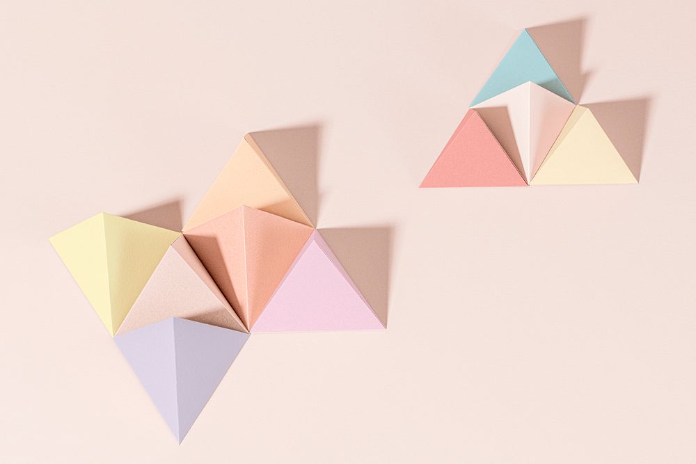 3D pastel pyramid paper craft on a pink background