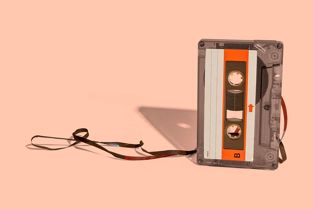 Old school cassette tape on a peach background 
