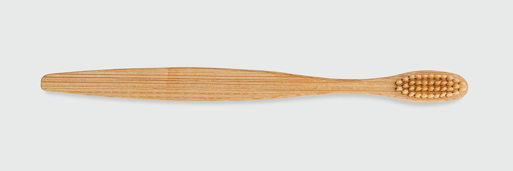 Natural bamboo toothbrush on off white background banner