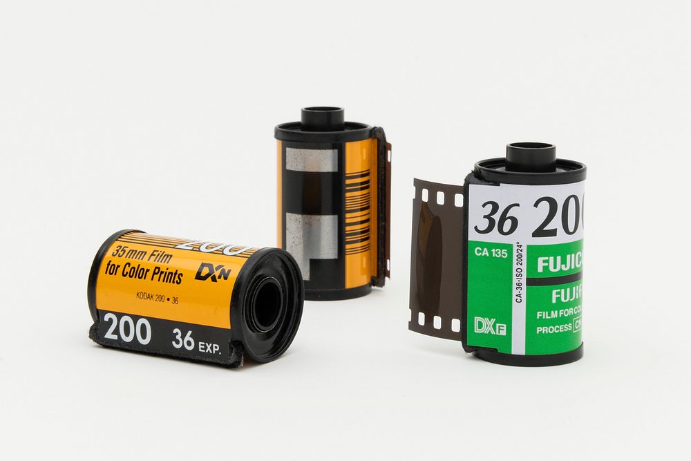 Three rolls of analog 35mm film on a white background. JANUARY 29, 2020 - BANGKOK, THAILAND