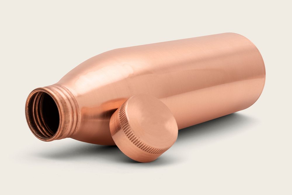 Copper water bottle mockup on an off white background