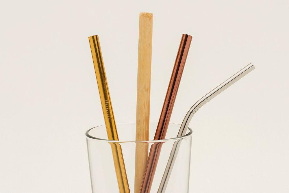 Reusable bamboo and metal straws in a glass 